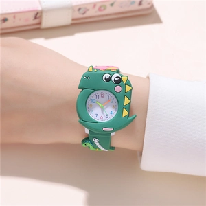 Detailed view of the green dinosaur silicone strap and dial on a child's quartz watch