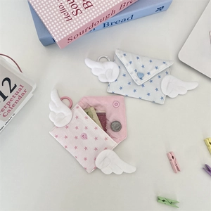 Close-up of cute wing mini coin purses with star pattern in light blue and pink fabric