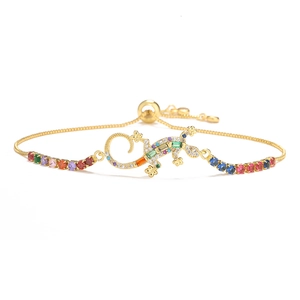 Detailed macro of gold-plated gecko bracelet with colorful zircon and adjustable chain