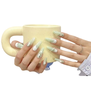 Mint green handmade press-on nails with 3D snake pattern and white feather textures