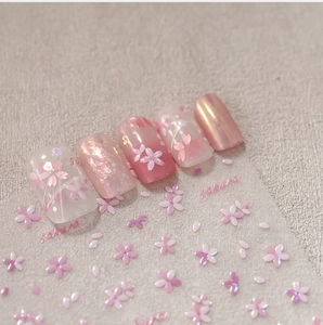 Close-up of 3D embossed pink sakura tulip nail stickers and gradient manicured nail tips