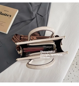 Internal view showing large capacity compartments and retro strap for the tote bag
