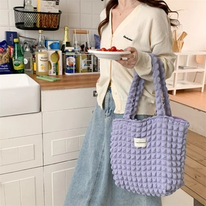Detail of lavender bubble textured tote bag featuring a stitched LOVE SOZAKKA label cloth