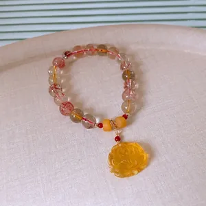 Rutilated quartz and red agate beaded bracelet with a delicate lotus carved charm