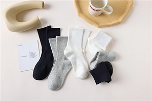 Flat lay of cotton crew socks in black, white and grey with ribbed texture detail