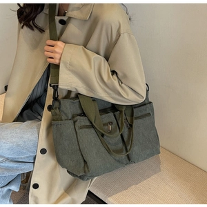Olive green corduroy crossbody bag with multi-pocket design and wide shoulder strap