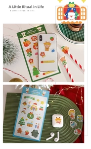 Close-up of DIY Christmas stickers on ceramic plate with warm holiday atmosphere