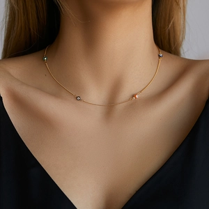 Exotic 18K gold plated brass necklace with colorful Evil Eye charms on model neck