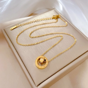 Golden titanium steel necklace with Roman numeral double ring pendant on white silk fabric
