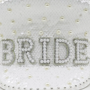 Macro shot of white sequin captain hat with BRIDE pearl rhinestone lettering