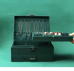 Detail view of emerald green velvet jewelry box with multi-layer storage and metal lock