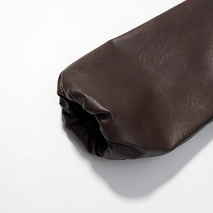 Macro shot of dark brown faux leather jacket sleeve with elastic pleated cuff details