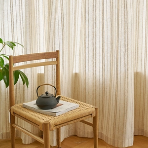 Japanese style striped linen sheer curtain with a wooden chair and iron teapot in sunlight