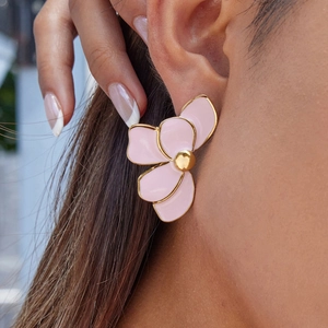 Close-up of pink enamel flower earrings with 18K gold plated steel edges on a model