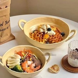 Macro view of a yellow ceramic sauce dish with bear handle, high-quality tableware