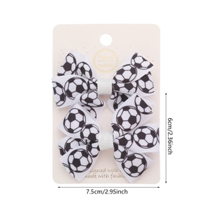 Set of two football print bow hair clips with soccer patterns on white background
