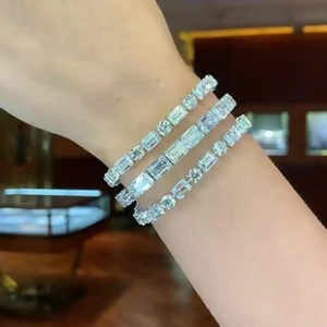 Detailed shot of three silver tennis bracelets with round and baguette cut cubic zirconia