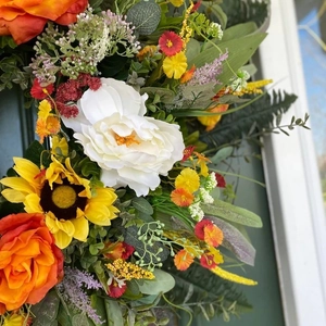 Summer door wreath with colorful eucalyptus peonies sunflowers and orange roses