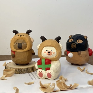 Macro view of hand-carved wooden animal ornaments with festive winter accessories