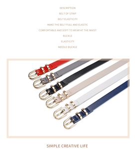 Detail of colorful elastic belts with gold pin buckles in red, black, and white colors