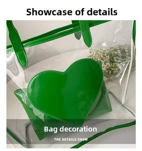 Top-down view of clear PVC tote with green heart detail and matching inner pouch
