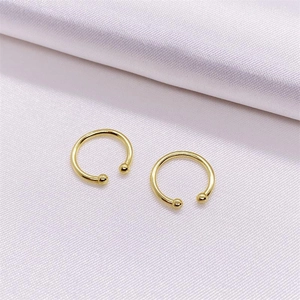 Close-up of gold-plated S925 sterling silver ear cuffs with smooth polished C-shaped design