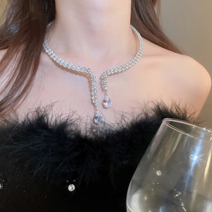 Detail of silver choker necklace with cubic zirconia tassels and water drop pendants