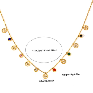 Detail of gold stainless steel necklace with colored zircons and dragonfly charms
