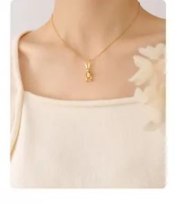 Mechanical bunny pendant in 18K gold plated finish shown on model with beaded chain