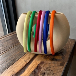 Detail of colorful satin headbands set in yellow, green, red, purple, blue, and orange