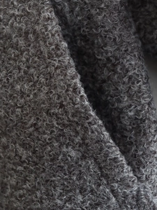 Macro shot of high-quality dark grey faux shearling texture and soft fleece fabric fibers