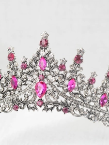 Macro view of crystal tiara with pink and clear rhinestones on silver metal frame