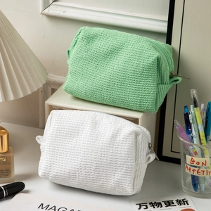 Large popcorn texture makeup bags in mint green and white with handles and zippers
