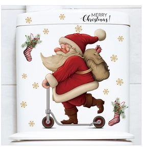 Detail view of Santa Claus and snowflake stickers on a white toilet water tank surface