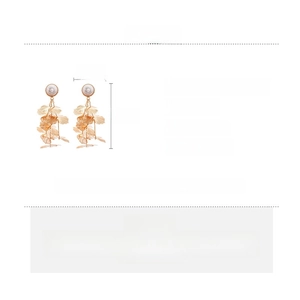 Detail view of hollow gold flower earrings with silver needle and size specifications