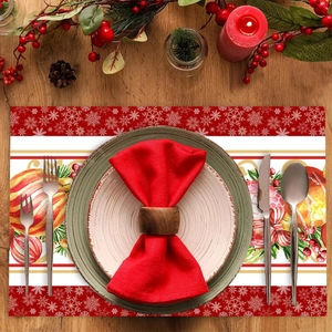 Red Christmas placemat with snowflakes and ornaments on a festive wooden dinner table