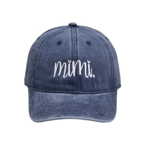Detail of mimi embroidery on a navy washed cotton baseball cap with vintage texture