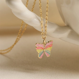 Golden necklace featuring a colorful enamel butterfly pendant for fashion jewelry lovers