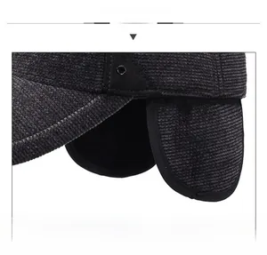 Detailed view of thick corduroy winter baseball cap with warm ear flaps and vent holes