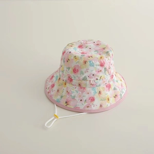 Detailed view of kids sun hat with floral print and adjustable white chin strap with buckle