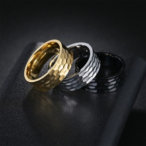 Detail of 8mm hammered texture titanium steel rings in gold, silver, and black colors