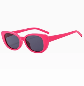 Detail view of stylish rose red cat-eye sunglasses with dark grey anti-UV lenses