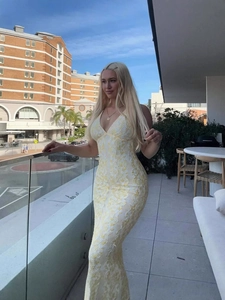 Elegant V-neck lace maxi dress in light yellow and white, featuring a slim fit and backless cut