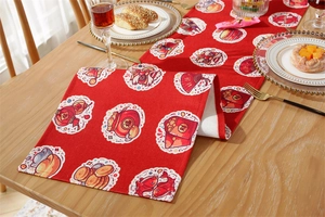 Close-up of festive red table runner with traditional lion dance and koi fish patterns