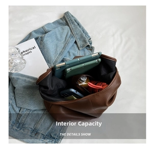 Detail view of large tote interior holding an iPad, water bottle and umbrella