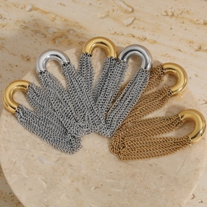 Modern curved gold and silver chain fringe earrings on a minimalist marble background