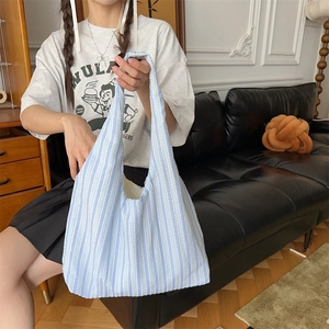 Close-up of light blue and white striped canvas tote bag showing soft fabric texture