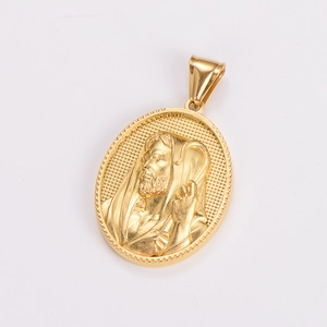 Detailed close-up of golden oval pendant featuring embossed Jesus icon on white background