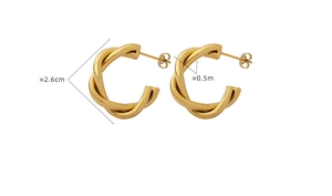 Macro shot of gold C-shaped twisted hoop earrings with 2.6cm diameter and 0.5cm width