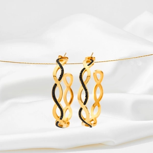 Elegant gold C-shaped braided hoop earrings with black zircon stones on white silk